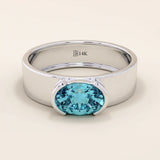 14k solid gold thick band ring with an oval cut topaz in a half bezel setting. Bold yet refined gemstone design. Perfect for stacking or solo wear.
