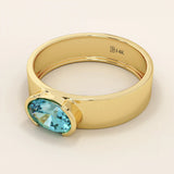 14k solid gold thick band ring with an oval cut topaz in a half bezel setting. Bold yet refined gemstone design. Perfect for stacking or solo wear.