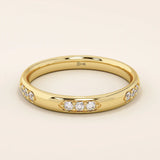 14k solid gold wedding band featuring a repeating trio moissanite pattern. A timeless and refined gold ring with subtle sparkle. Perfect for weddings or everyday wear.