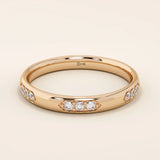 14k solid gold wedding band featuring a repeating trio moissanite pattern. A timeless and refined gold ring with subtle sparkle. Perfect for weddings or everyday wear.