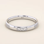 14k solid gold wedding band featuring a repeating trio moissanite pattern. A timeless and refined gold ring with subtle sparkle. Perfect for weddings or everyday wear.