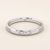 14k solid gold wedding band featuring a repeating trio moissanite pattern. A timeless and refined gold ring with subtle sparkle. Perfect for weddings or everyday wear.