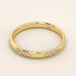 14k solid gold wedding band featuring a repeating trio moissanite pattern. A timeless and refined gold ring with subtle sparkle. Perfect for weddings or everyday wear.