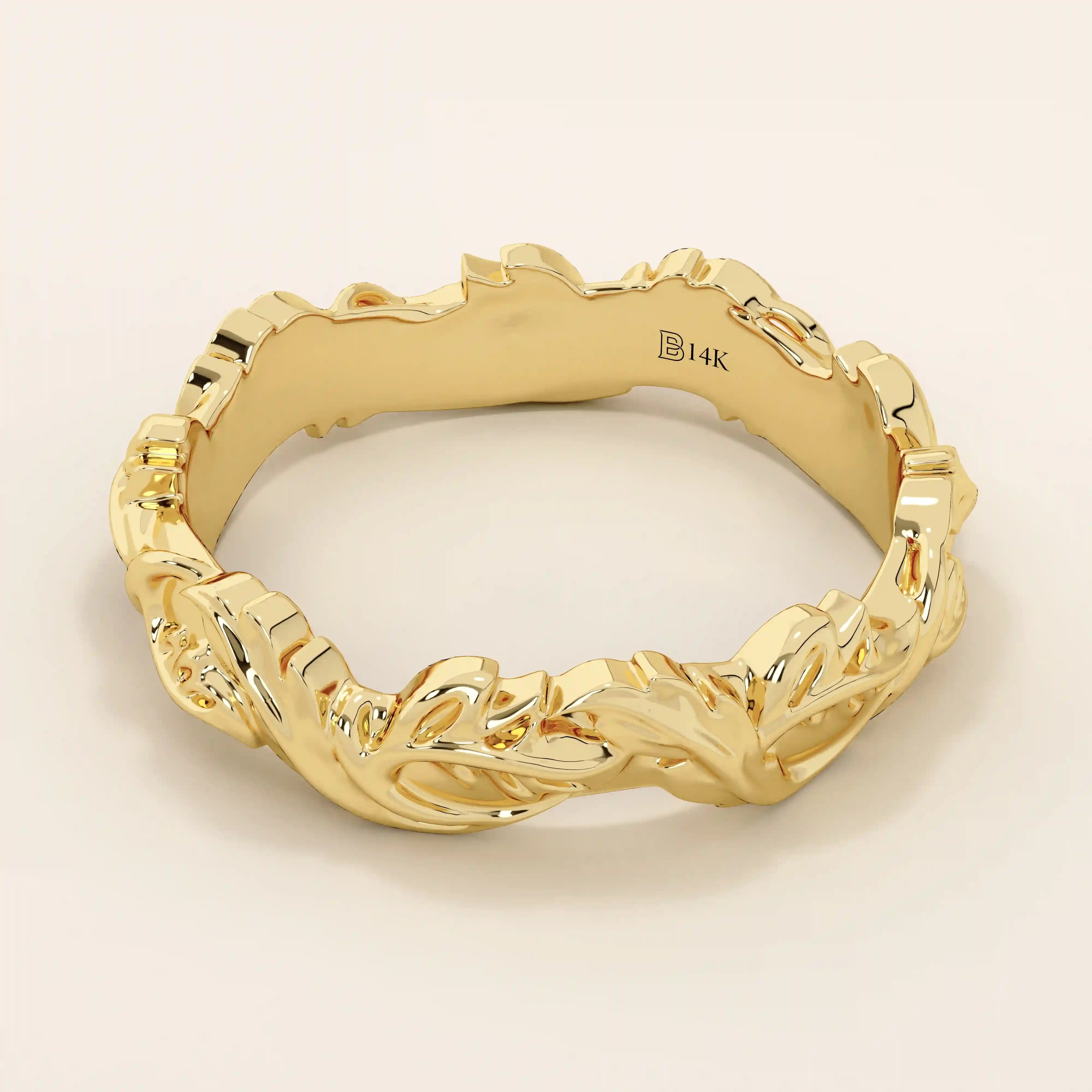 Side profile of a 14k solid yellow gold wedding band with raised ivy leaf detailing and organic vine-like curves wrapping around the ring. The alternating high-polish surfaces and recessed details create a striking play of light and texture.