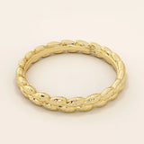 14k solid gold wedding band with a delicate vine pattern wrapping around the band. Nature-inspired and detailed gold ring. Ideal for everyday wear or as a unique wedding band.