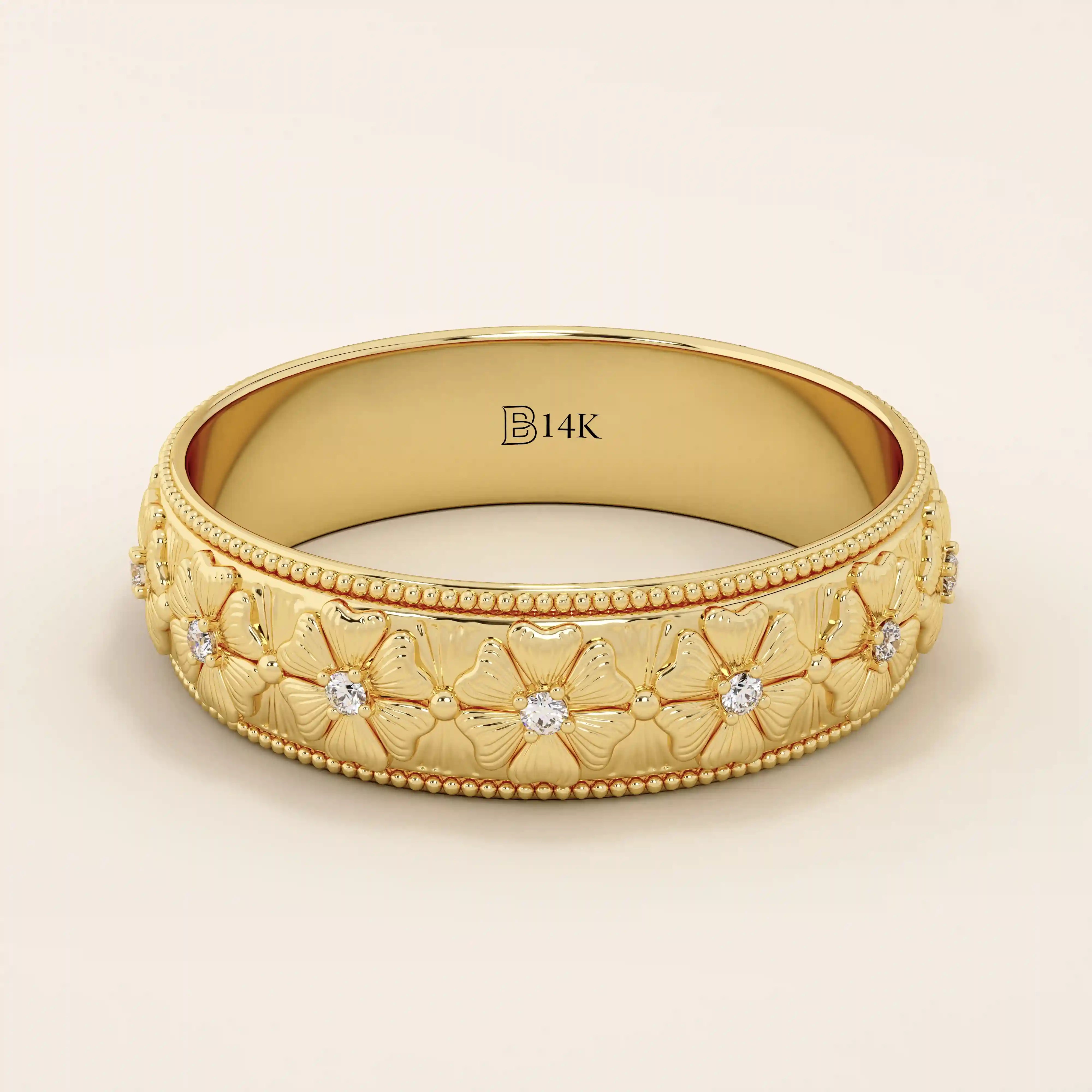 14k solid gold wedding band with embossed flower patterns wrapping around the band. A romantic and textured gold ring. Perfect for daily wear or as a unique wedding band.