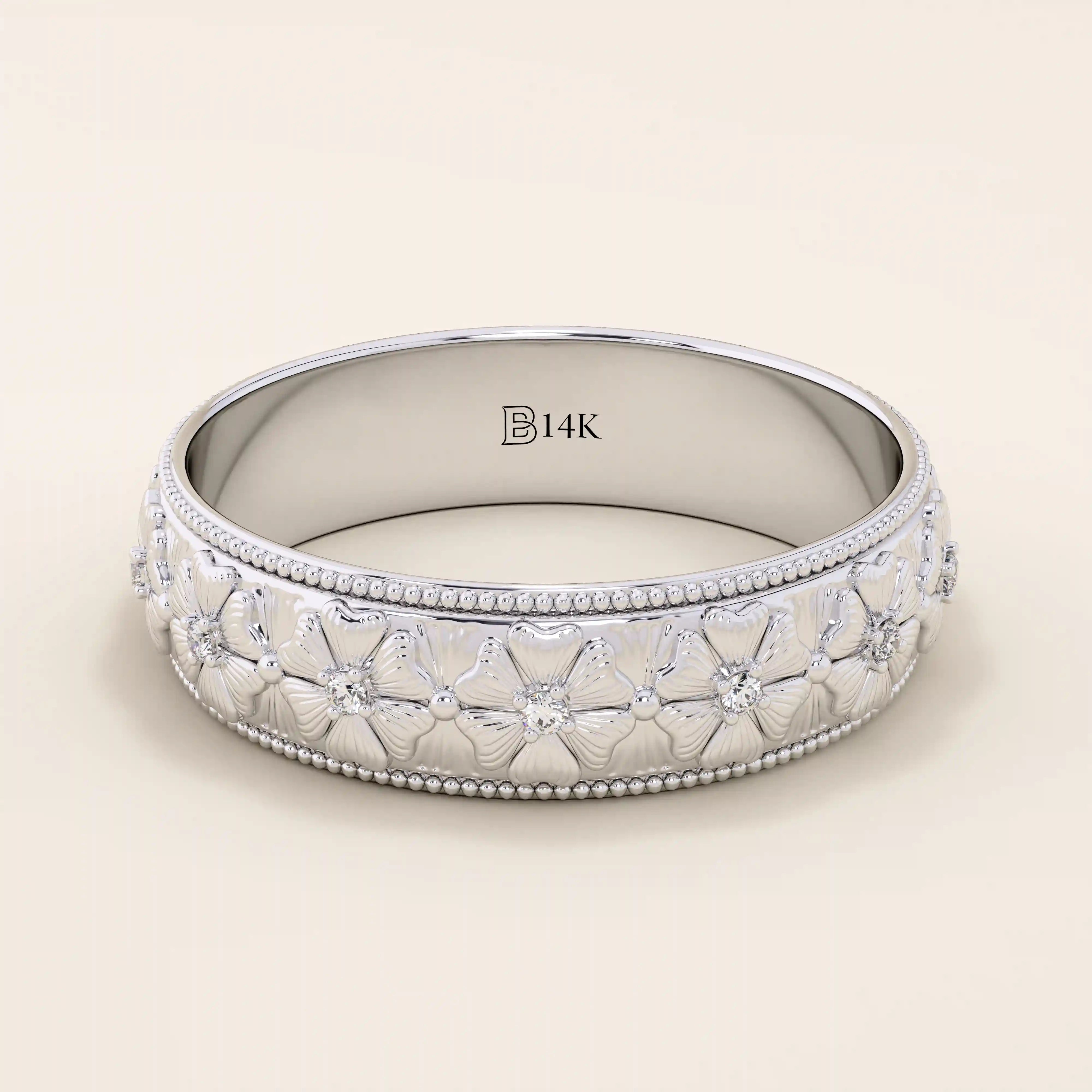 14k solid gold wedding band with embossed flower patterns wrapping around the band. A romantic and textured gold ring. Perfect for daily wear or as a unique wedding band.