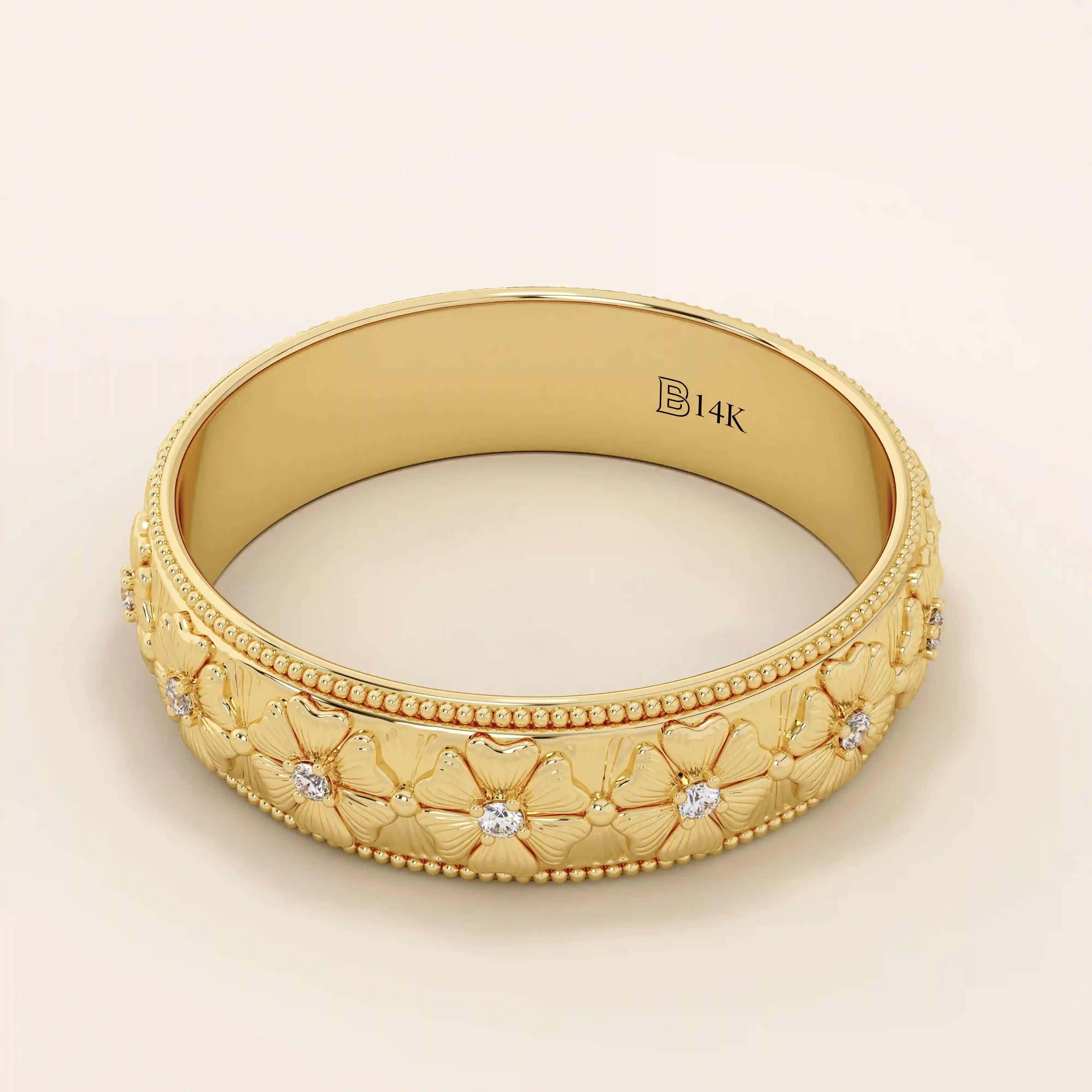 14k solid gold wedding band with embossed flower patterns wrapping around the band. A romantic and textured gold ring. Perfect for daily wear or as a unique wedding band.