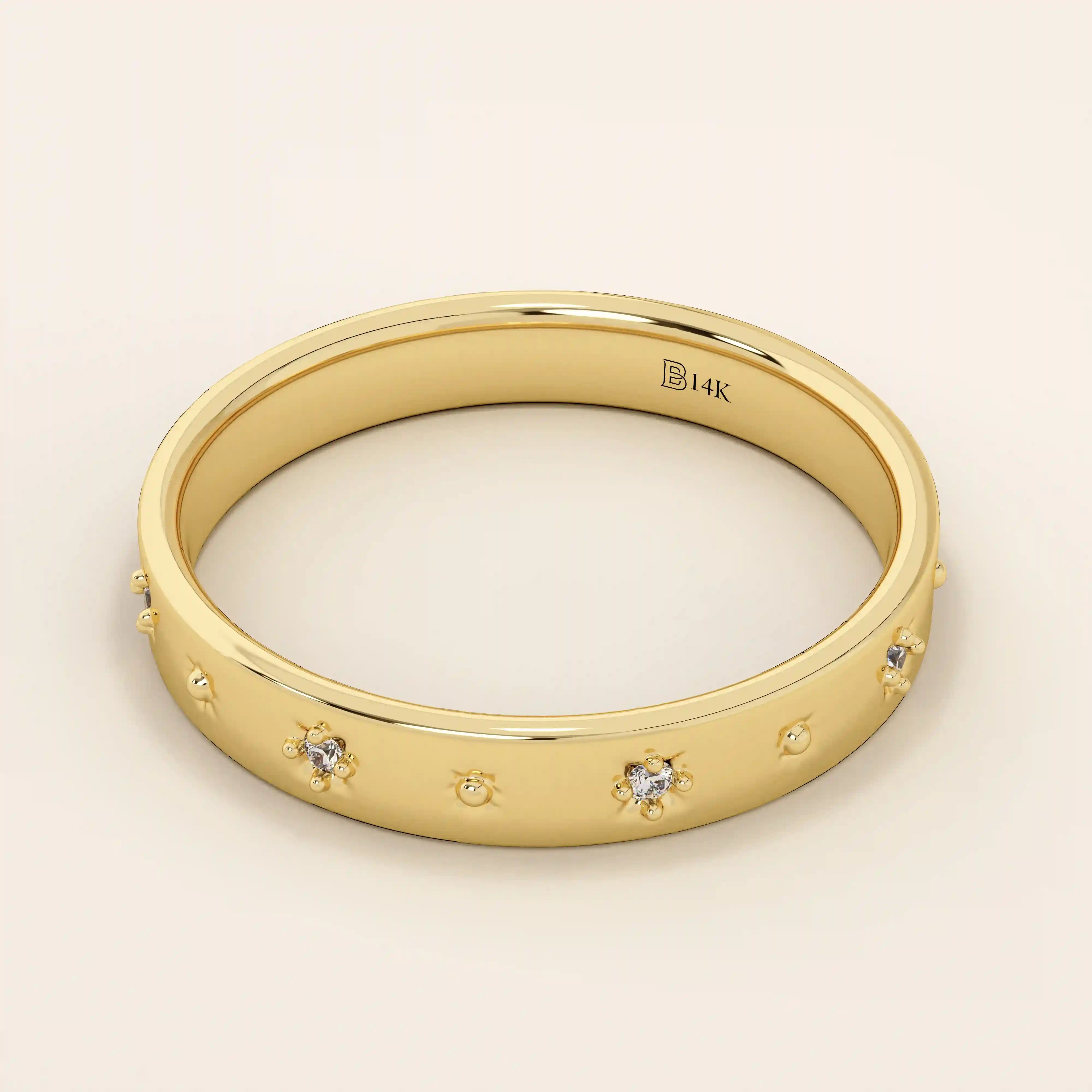 Side angle view of a 14k solid yellow gold wedding band showcasing raised star motifs with inset round moissanites, the highly polished edges enhancing its celestial charm.