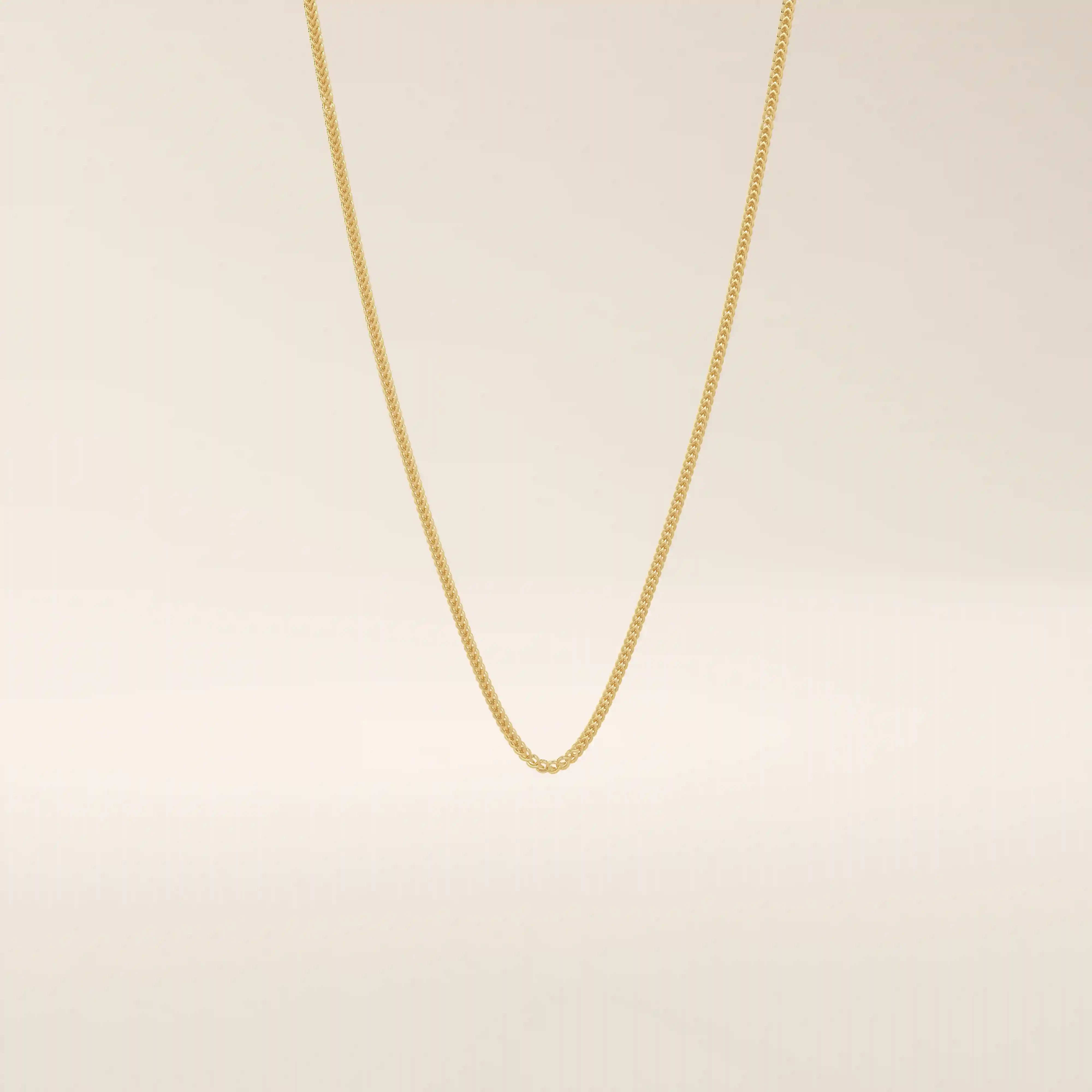 14k solid gold wheat chain necklace with a smooth, tightly woven texture. A classic gold chain with timeless appeal. Ideal for daily wear or layering.