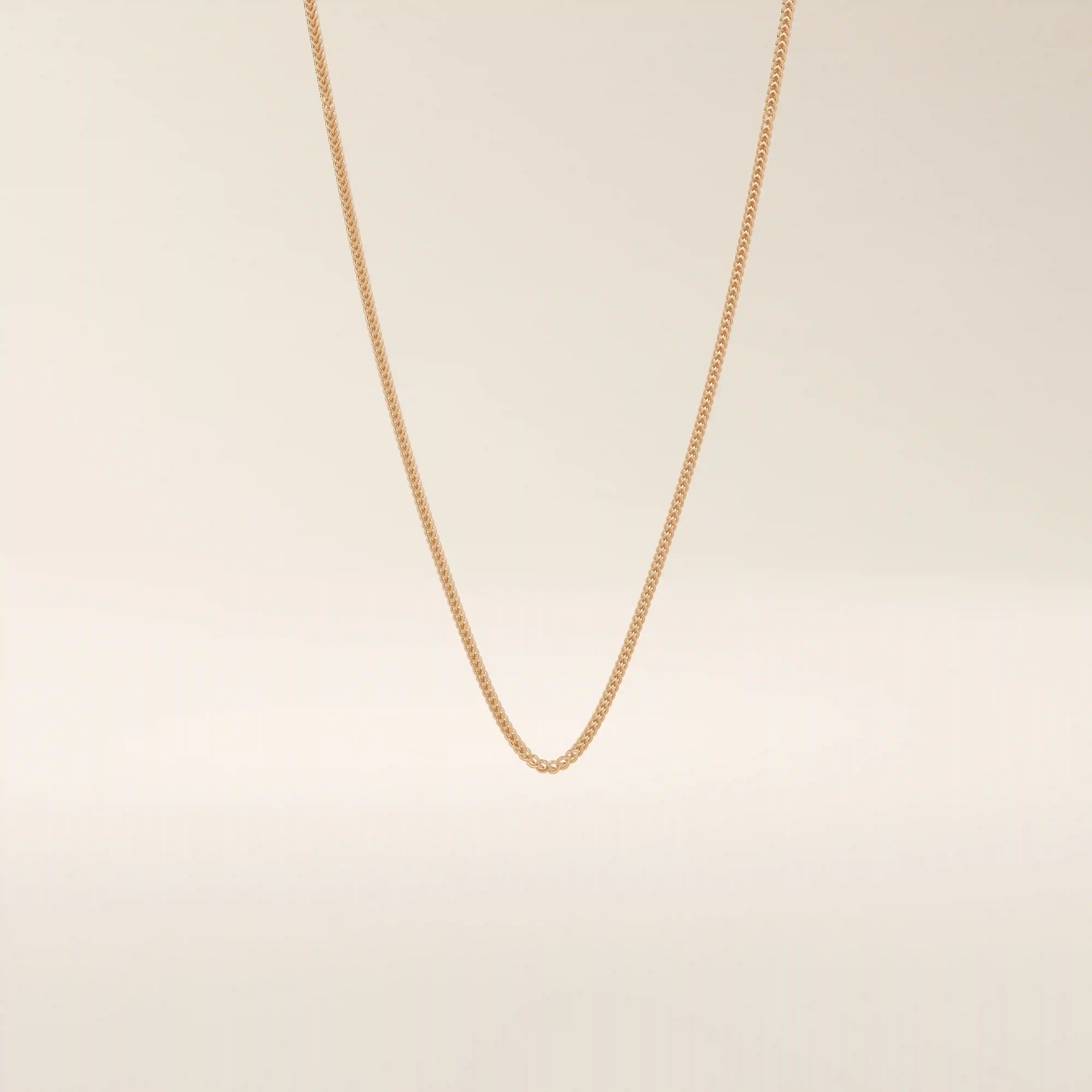 14k solid gold wheat chain necklace with a smooth, tightly woven texture. A classic gold chain with timeless appeal. Ideal for daily wear or layering.