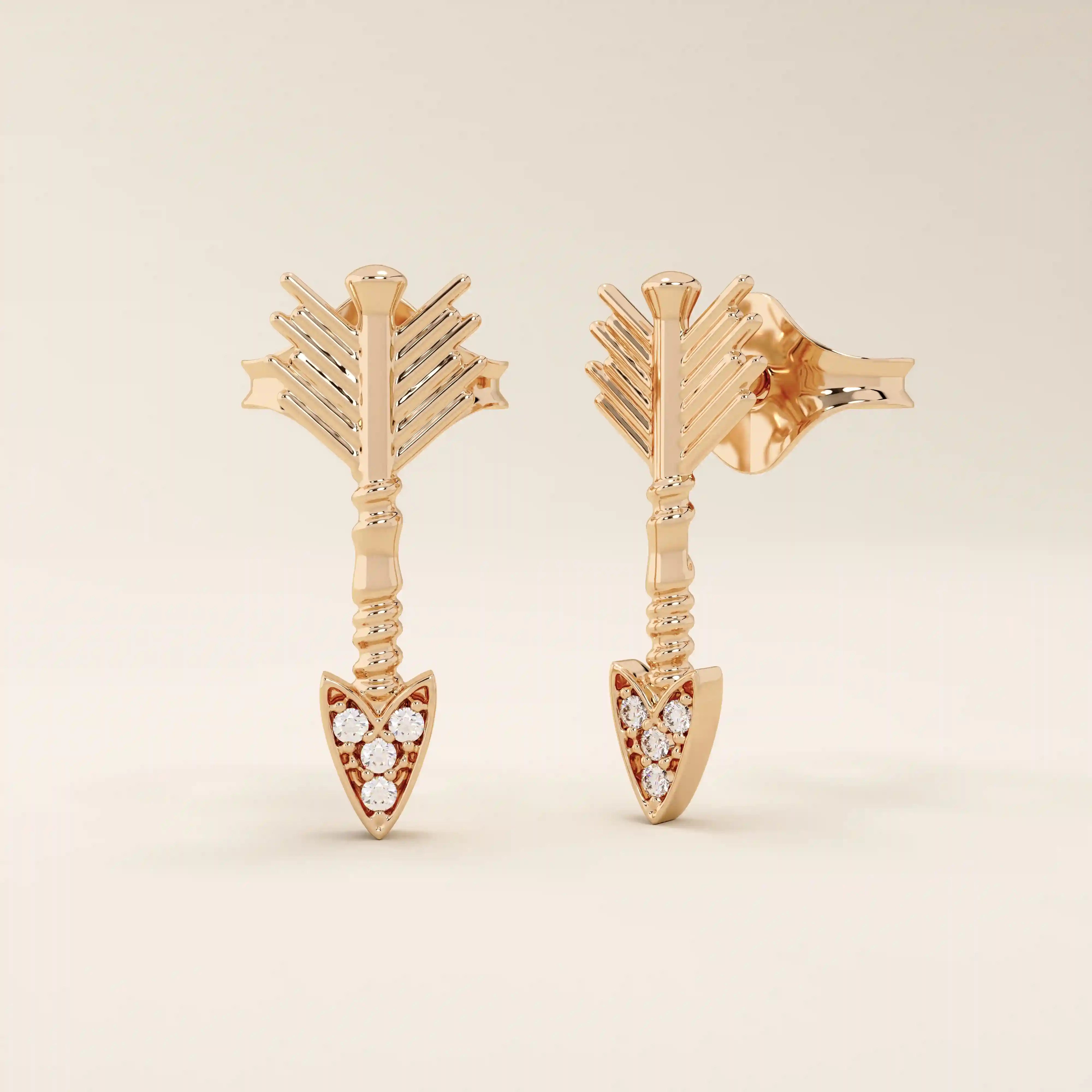 14k solid rose gold arrow-shaped stud earrings, showcasing delicate feathered ends and a pointed tip encrusted with white moissanite stones.
