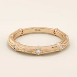 14k solid rose gold bamboo-inspired wedding band with evenly spaced round brilliant-cut moissanites
