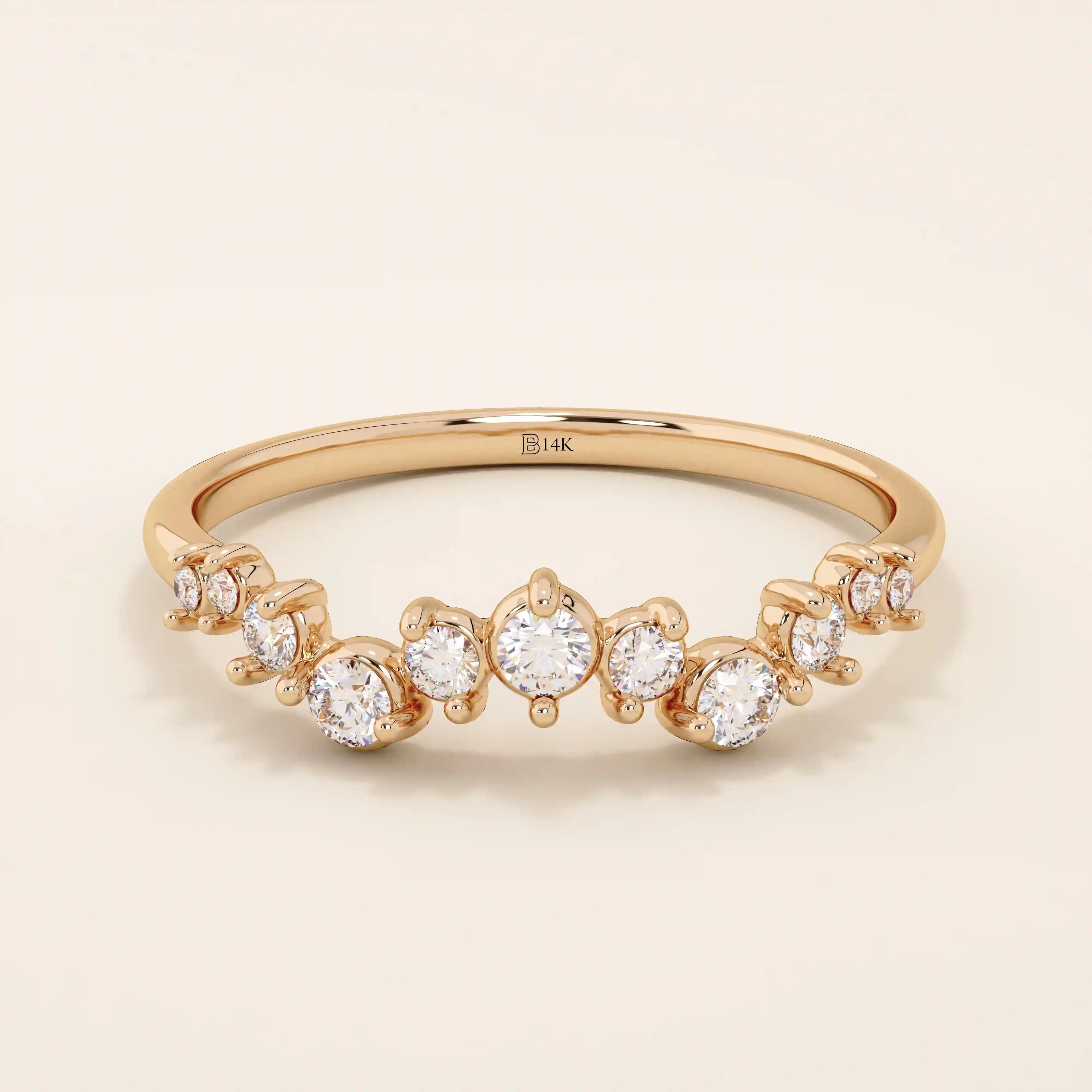 14k solid rose gold band adorned with a sequence of graduated moissanite stones in a delicate pavé setting.