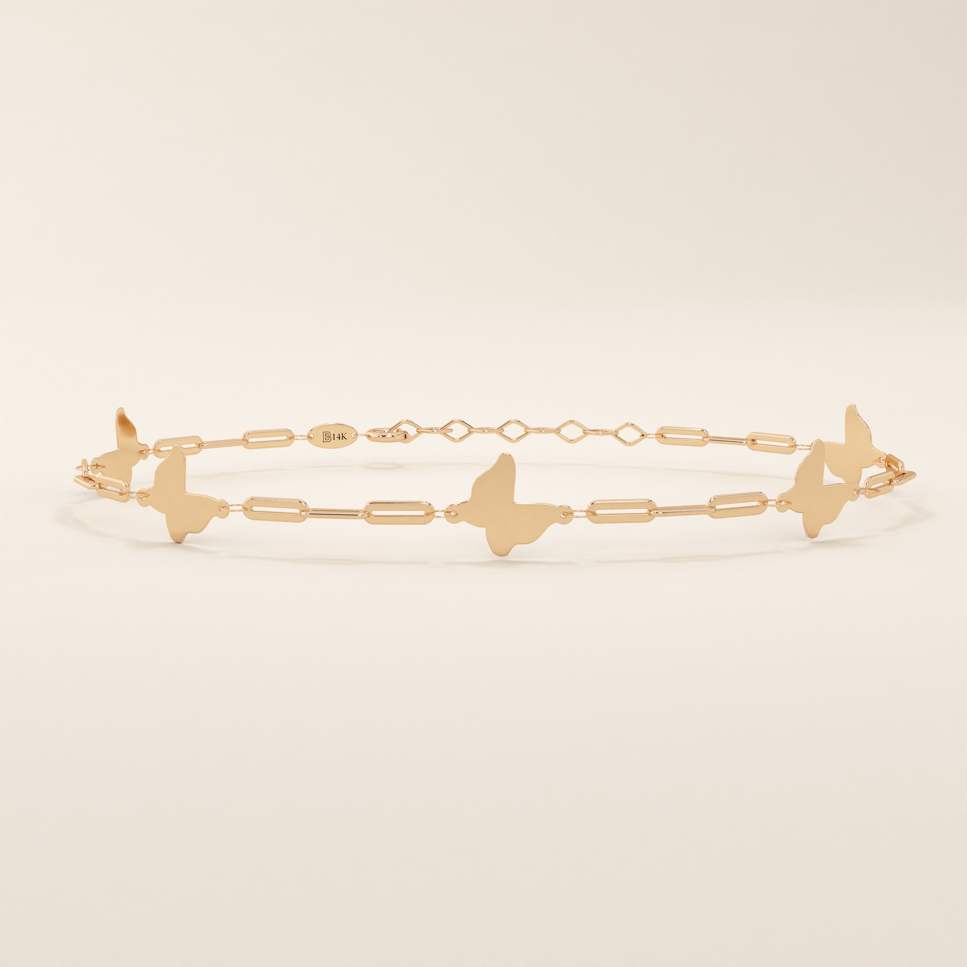 14k solid rose gold butterfly charm bracelet showcasing dainty butterfly designs joined with slim geometric chain links.