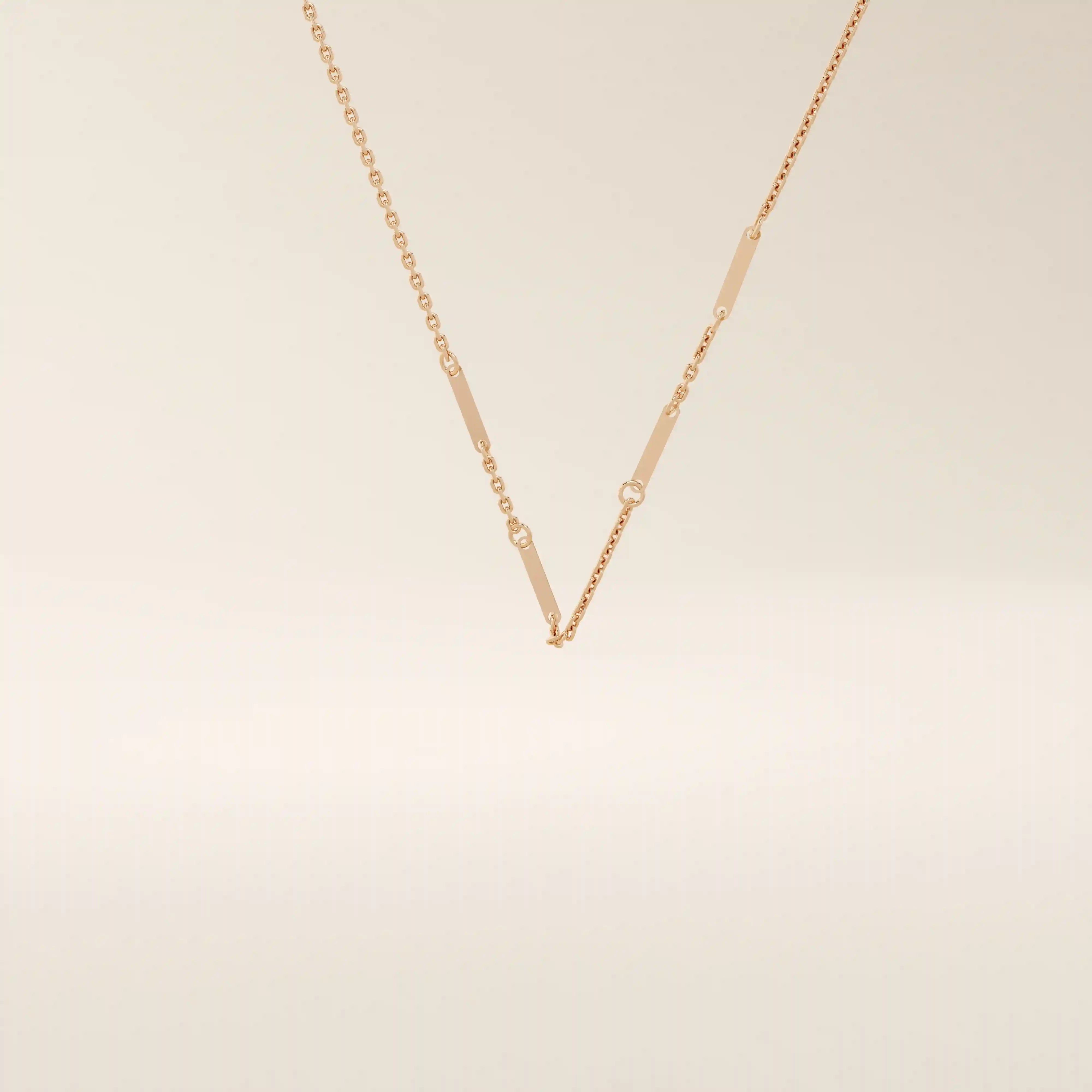 14k solid rose gold flat bar chain necklace showcasing slim rectangular bar stations placed evenly along the chain, blending warm tones with a contemporary design.
