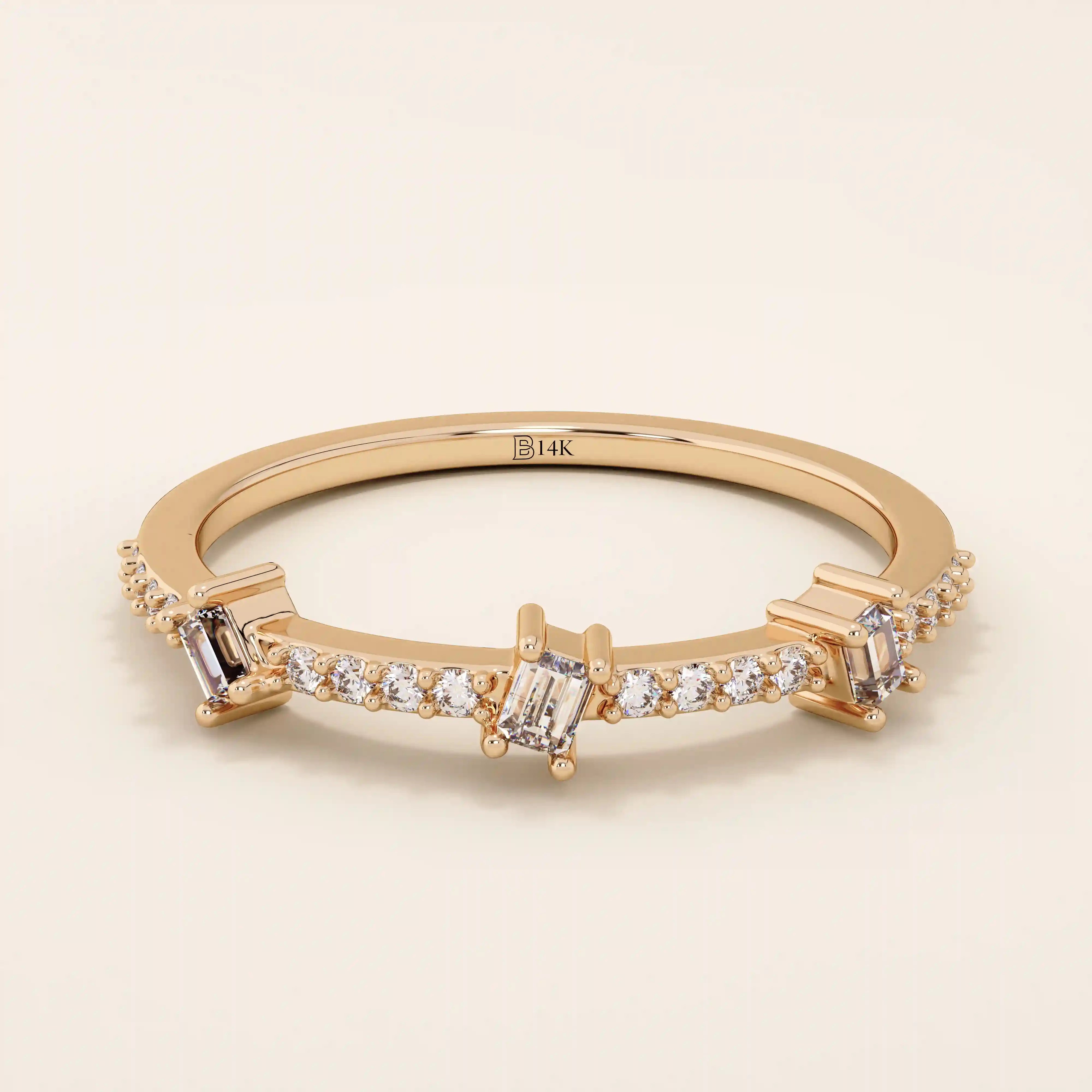 14k solid rose gold ring showcasing three baguette cut moissanite stones interspersed with pavé set round moissanite accents, romantic and contemporary fine jewelry gift