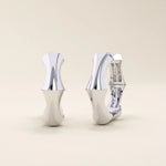 14k solid white gold bone-style hoop earrings featuring fluid organic curves, sharp detailing, and a sleek polished finish.