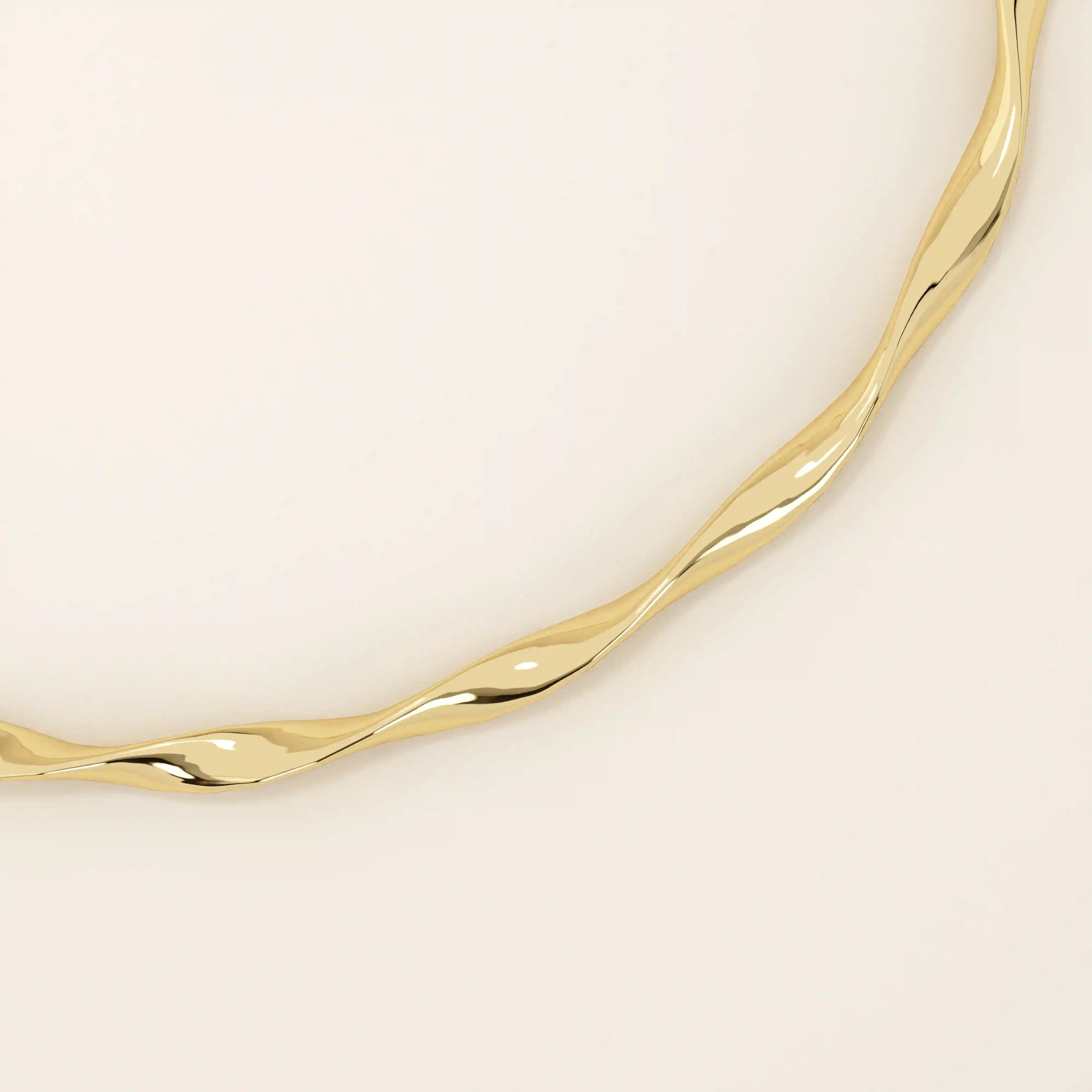 14k solid yellow gold bangle bracelet featuring a twisted, wave-like design that catches the light from every angle, offering a fluid and elegant aesthetic.