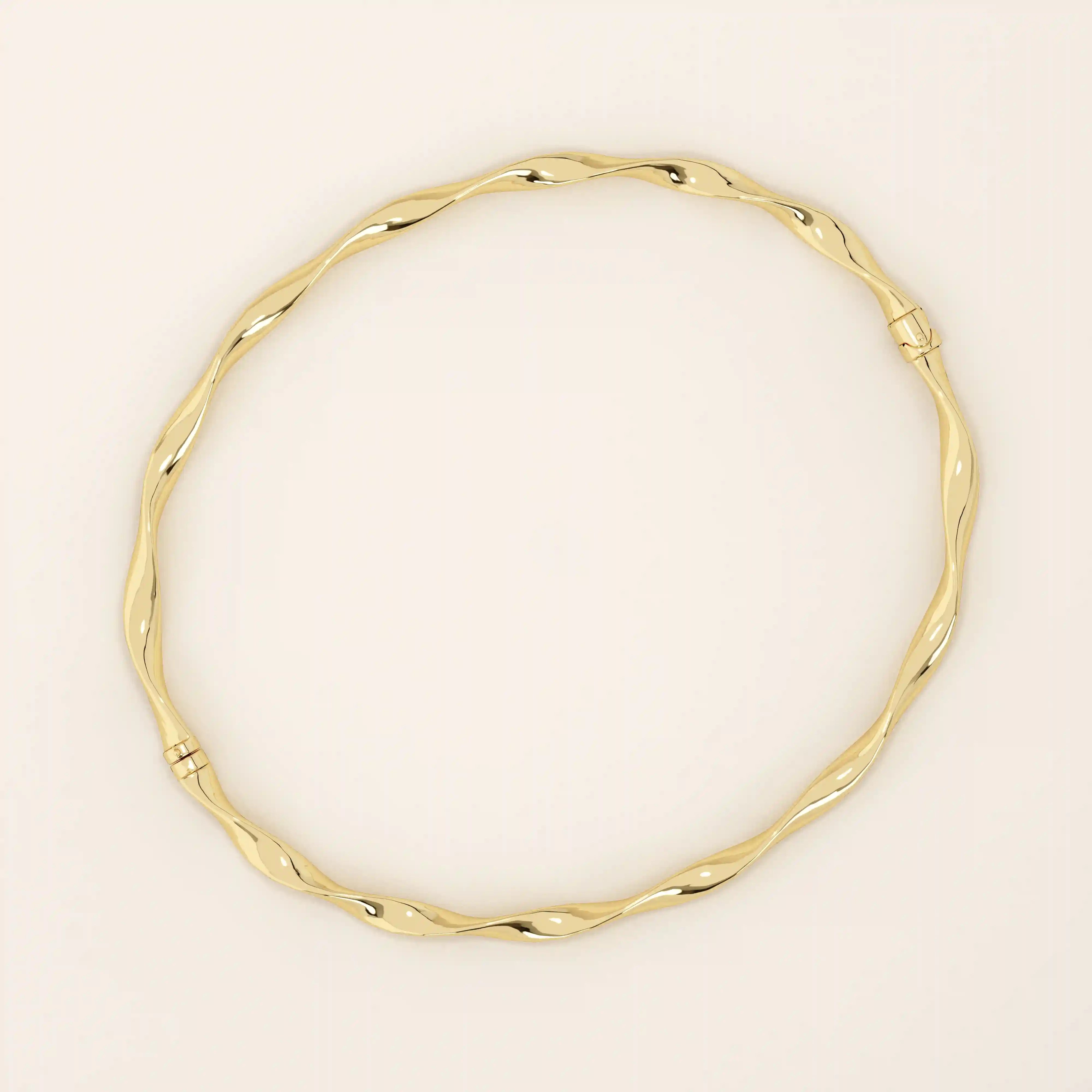 14k solid yellow gold bangle bracelet featuring a twisted, wave-like design that catches the light from every angle, offering a fluid and elegant aesthetic.
