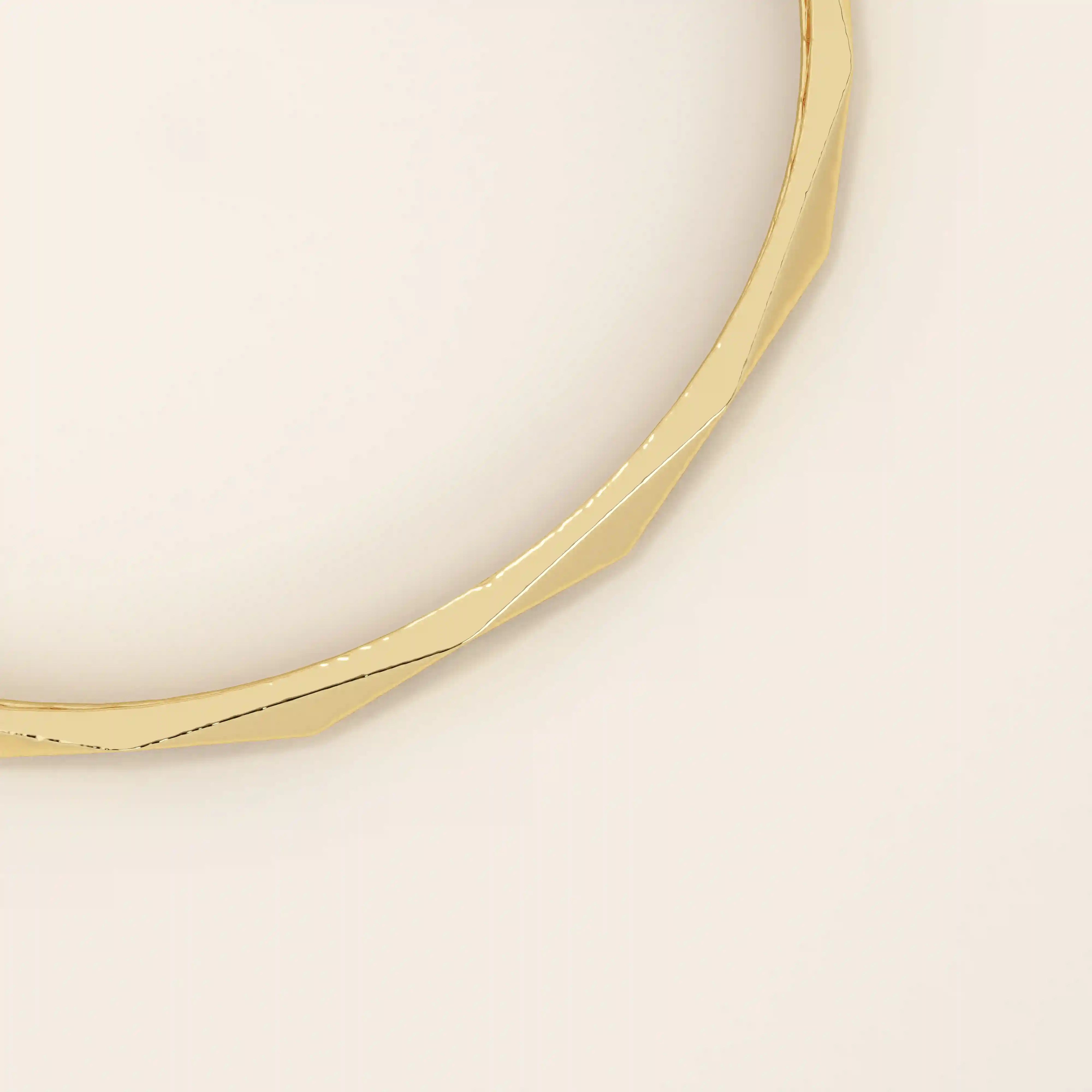 14k solid yellow gold bangle bracelet with a sleek faceted design, featuring geometric angled cuts that reflect light beautifully for a modern, sophisticated look.