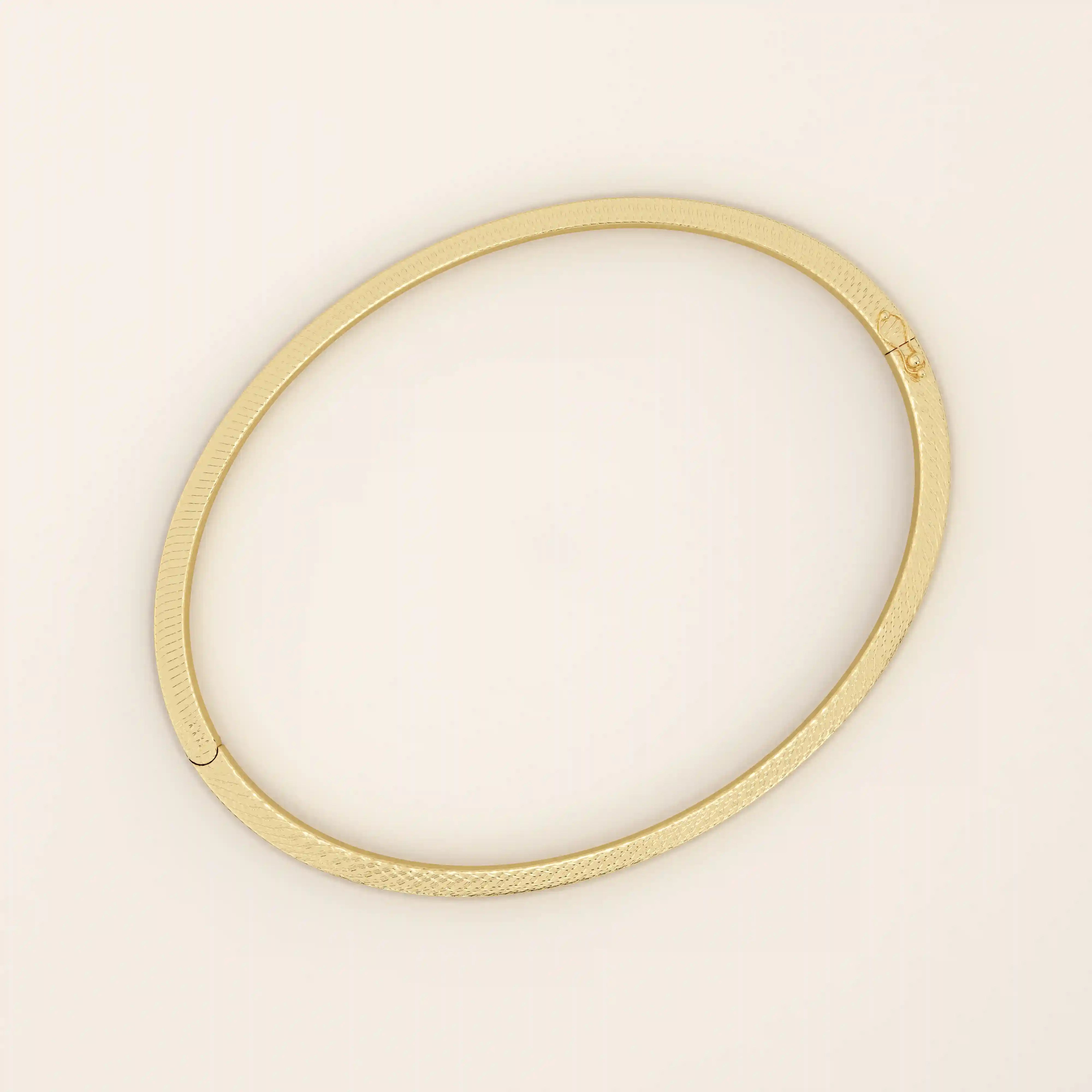 14k solid yellow gold textured square tube bangle bracelet with a slim polished band and subtle geometric detail.