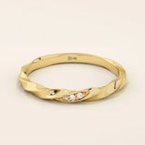 14k solid yellow gold twisted wedding band with a cluster of round brilliant moissanites set in a marquise-shaped opening, modern and elegant design