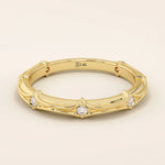 14k solid yellow gold wedding band with a bamboo-inspired design, featuring evenly spaced round brilliant-cut moissanites