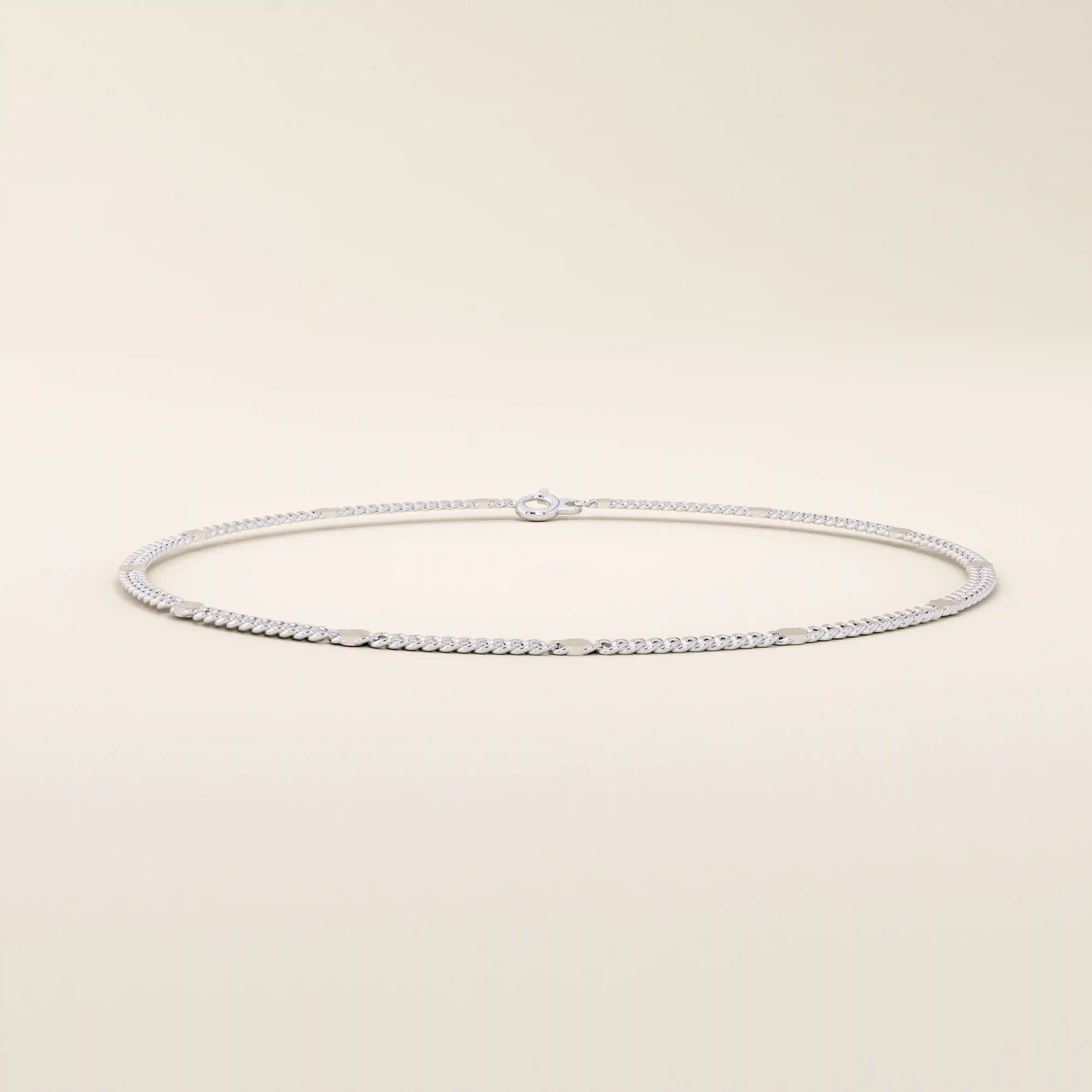 14k white gold bracelet featuring a curb link chain design with smooth round disc accents.