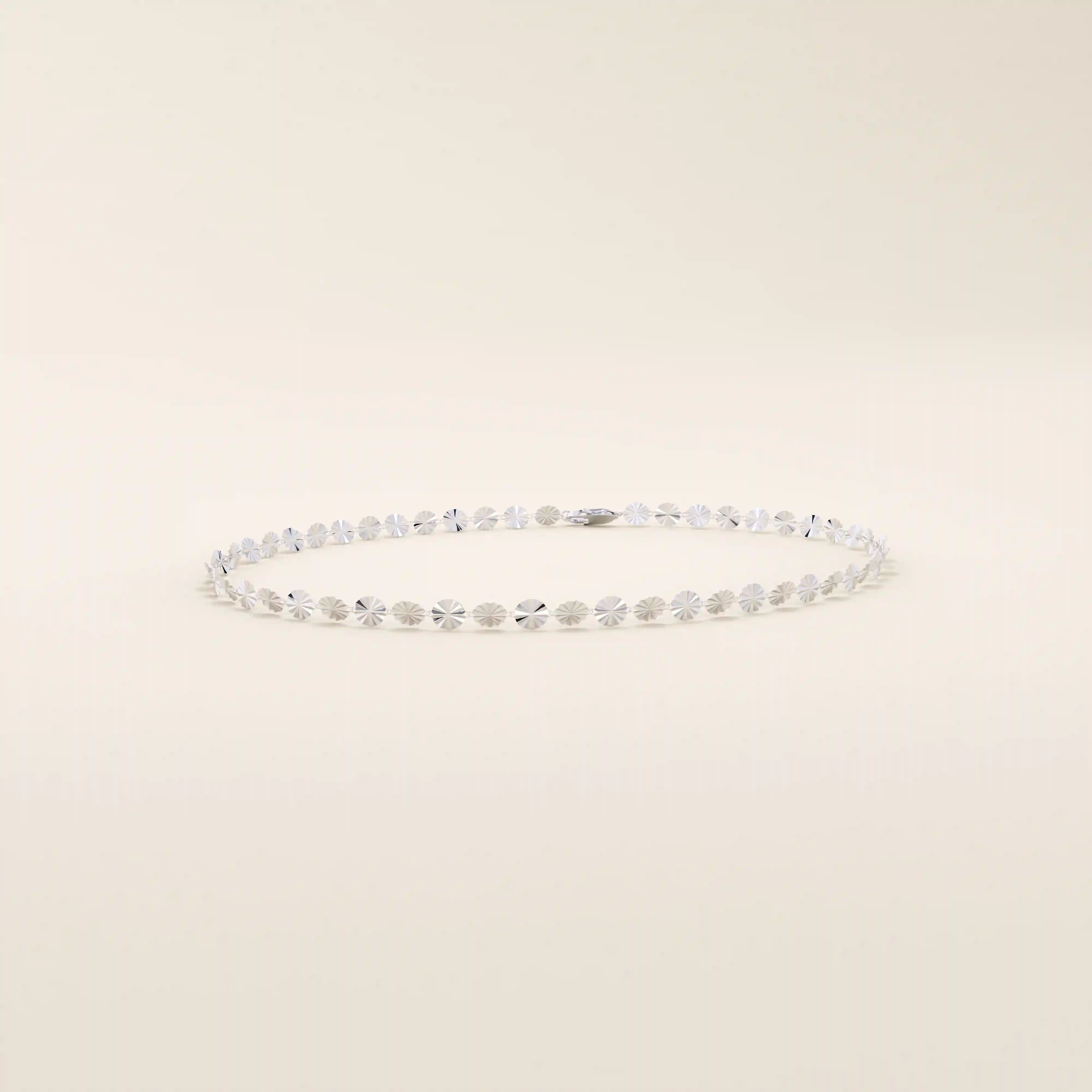 14k white gold bracelet with polished textured discs, each showcasing a radiant starburst effect.