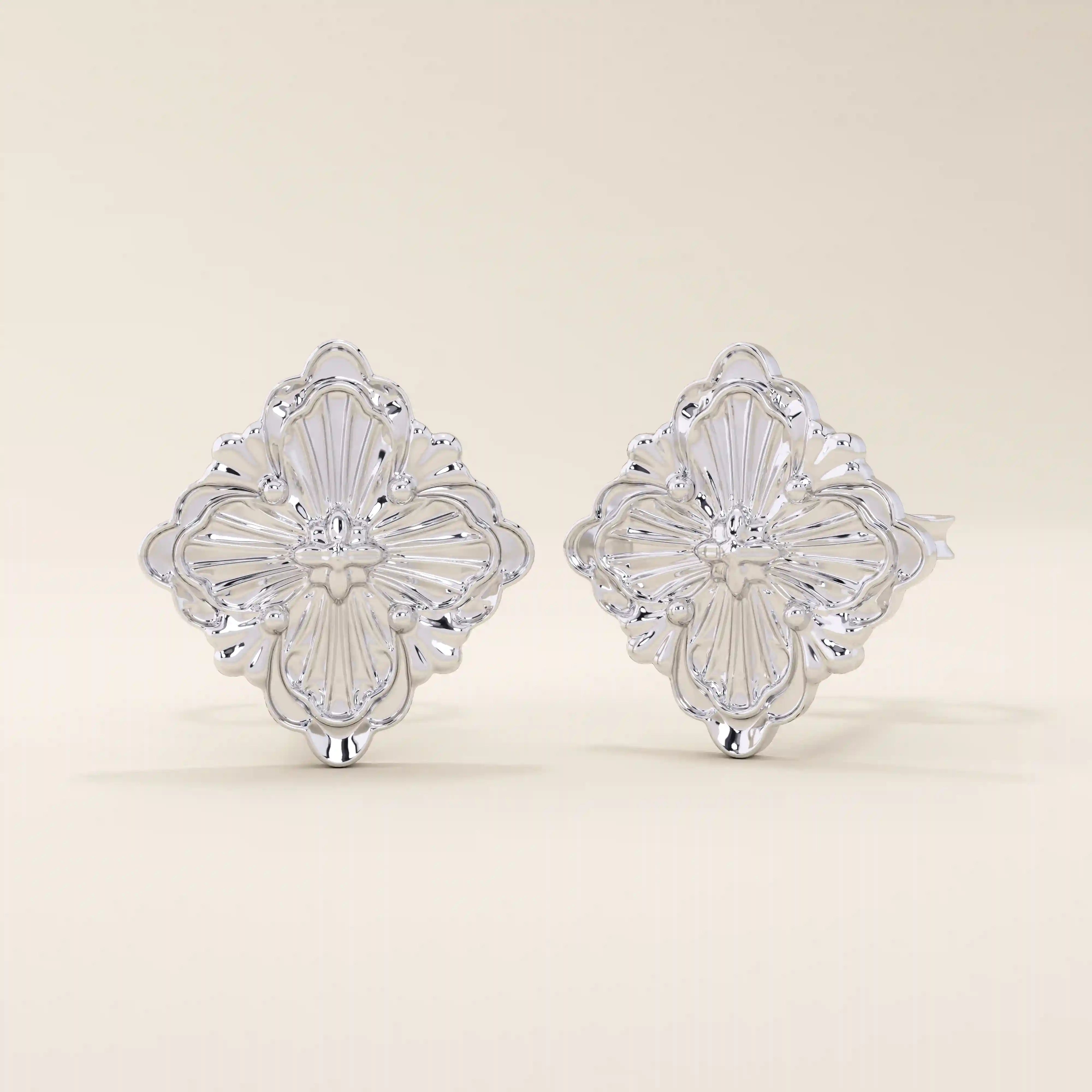 14k white gold stud earrings featuring an embossed clover motif with intricate vintage-style detailing.