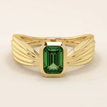 A vintage-style statement ring crafted in 14k solid gold, featuring a bezel-set emerald cut green gemstone at the center. The rectangular stone sits vertically on a thick polished gold band.