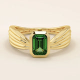 A vintage-style statement ring crafted in 14k solid gold, featuring a bezel-set emerald cut green gemstone at the center. The rectangular stone sits vertically on a thick polished gold band.