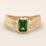A vintage-style statement ring crafted in 14k solid gold, featuring a bezel-set emerald cut green gemstone at the center. The rectangular stone sits vertically on a thick polished gold band.