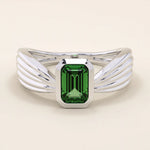 A vintage-style statement ring crafted in 14k solid gold, featuring a bezel-set emerald cut green gemstone at the center. The rectangular stone sits vertically on a thick polished gold band.