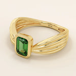 A vintage-style statement ring crafted in 14k solid gold, featuring a bezel-set emerald cut green gemstone at the center. The rectangular stone sits vertically on a thick polished gold band.