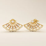 Angled view of 14k solid yellow gold fan stud earrings, showing the dimensional openwork pattern and the brilliance of baguette and round moissanites.