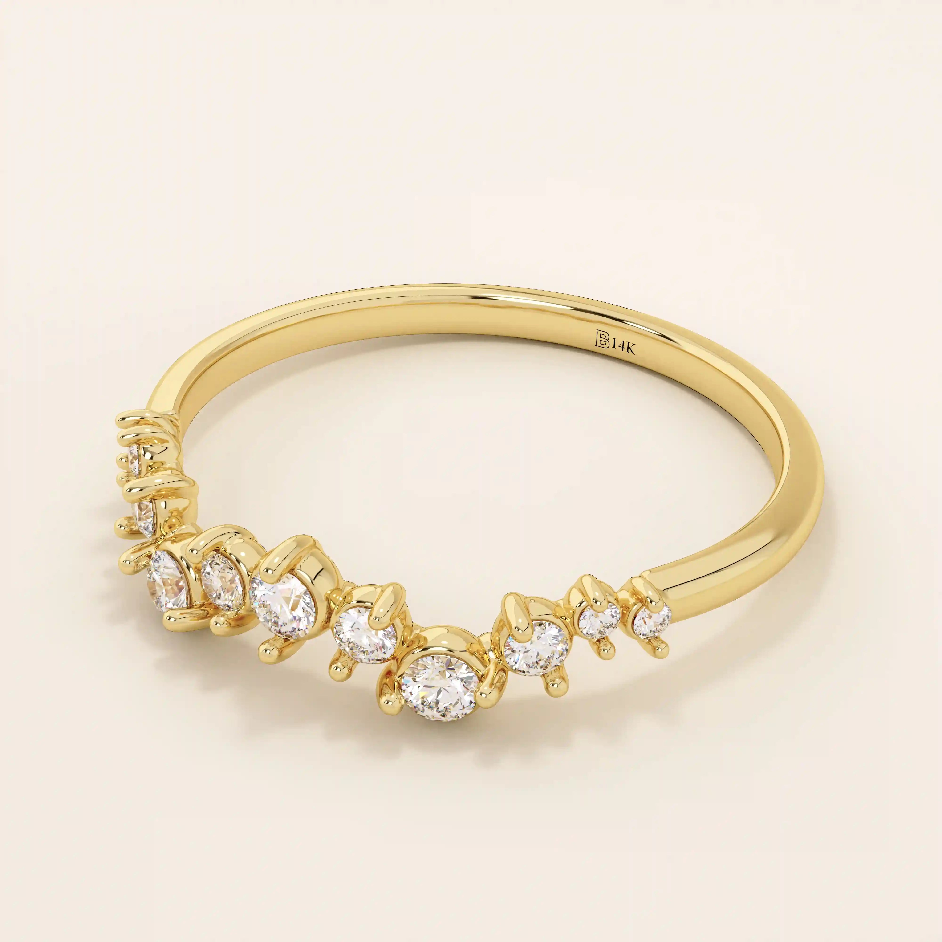 Angled view of a 14k yellow gold ring with alternating small and large moissanites in an elegant curved design.