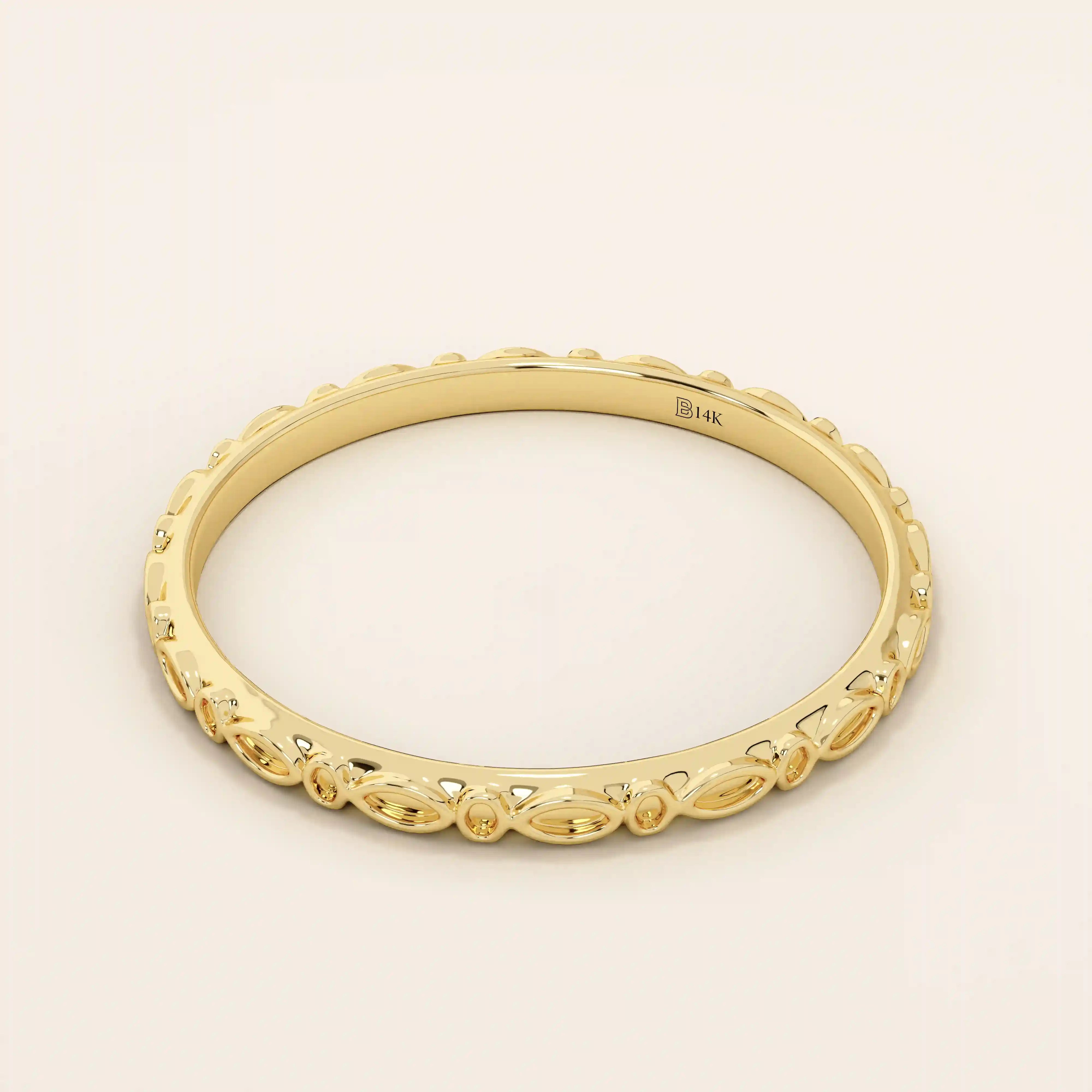 Angled view of a 14k yellow gold slim patterned wedding ring with repeating marquise shapes.