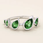Bold 14k gold ring with five pear-cut emerald gemstones. A vibrant and eye-catching statement ring with rich green tones.