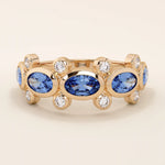 Bold gold ring with five bezel set oval sapphire gemstones. A striking statement ring with a unique symmetrical design.