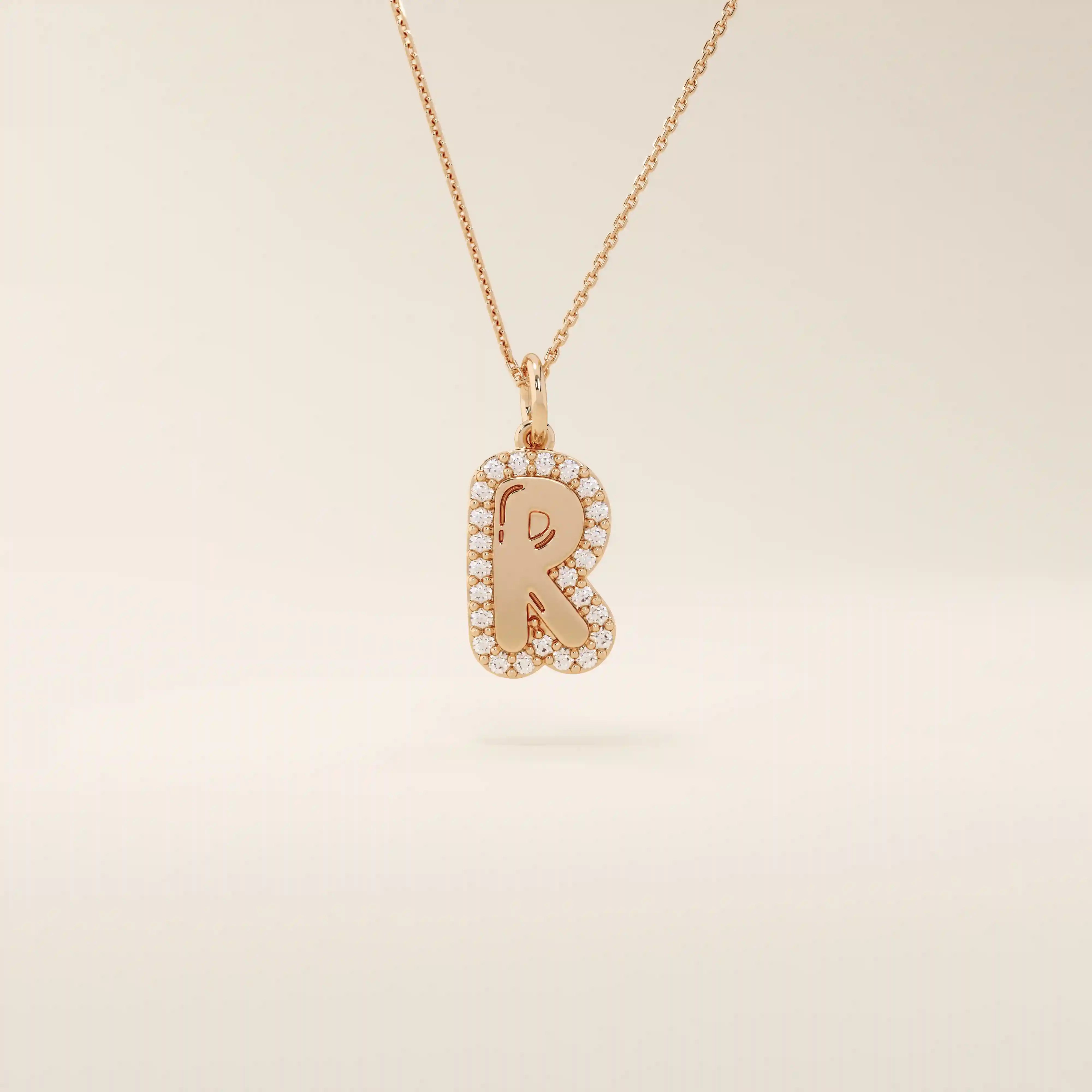 Bubble font initial pendant in 14k solid gold, framed with a halo of shimmering moissanites. A bold yet playful personalized necklace.