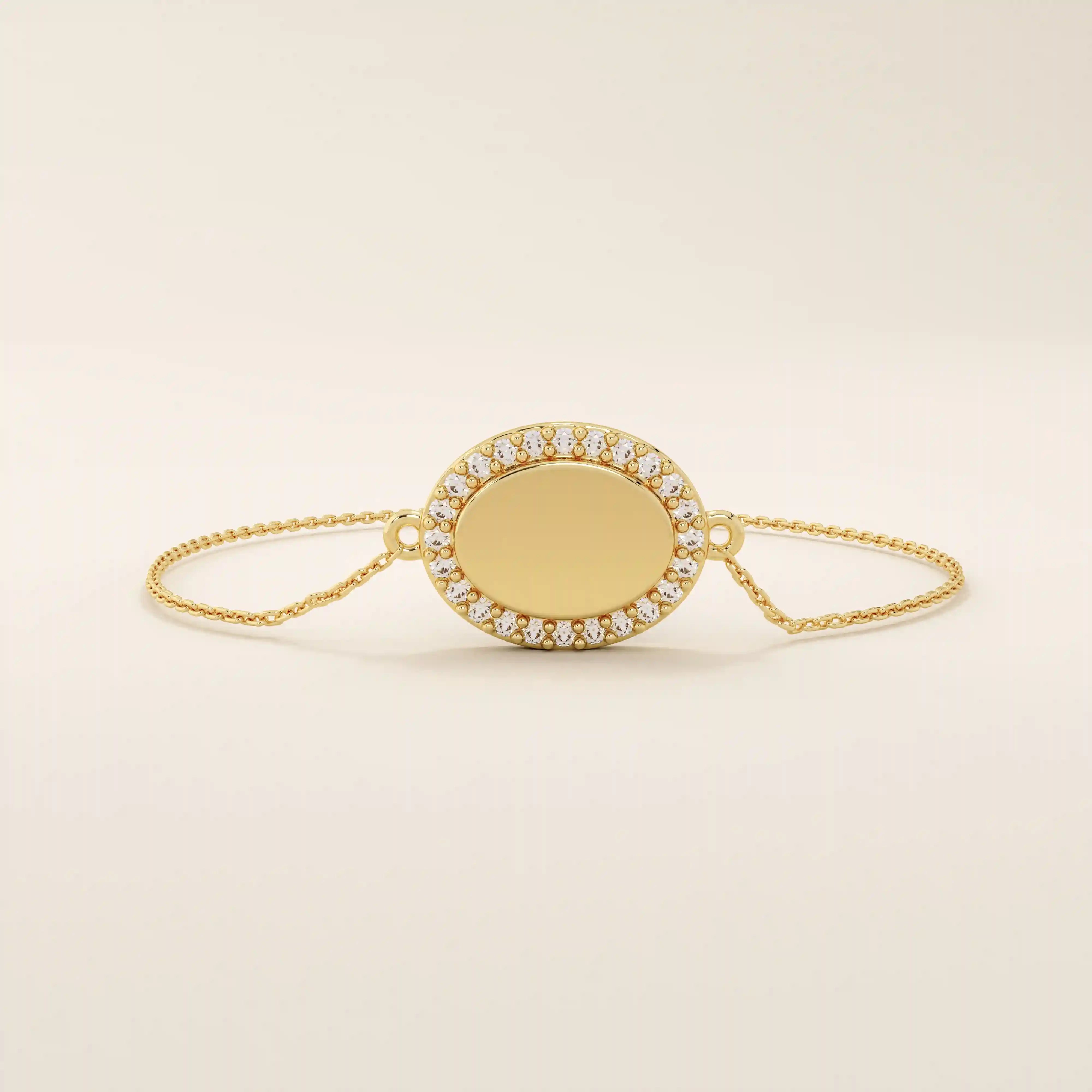 Close-up of an oval gold bracelet highlighting the pavé moissanite halo surrounding the polished oval centerpiece.