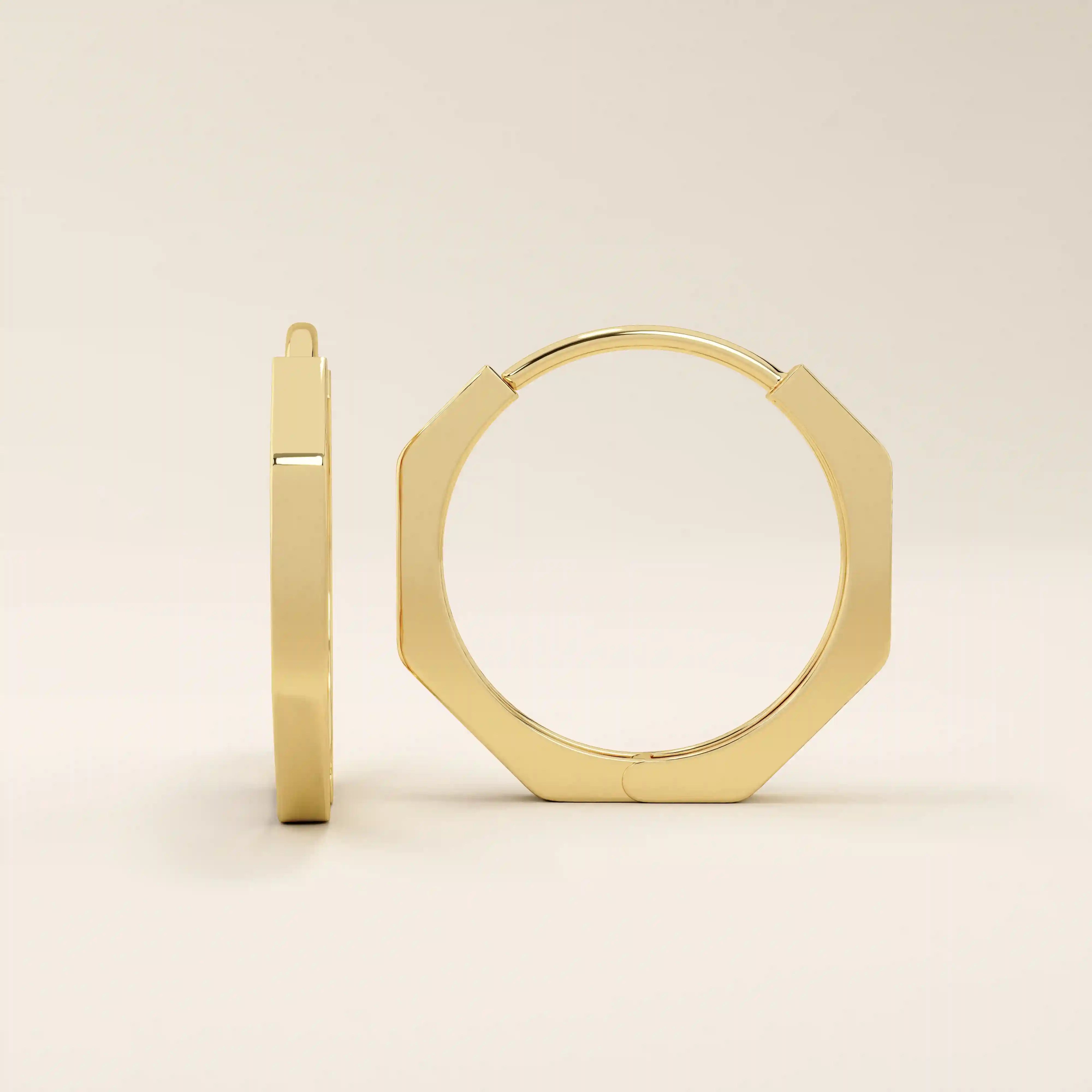 Close-up of small minimal hoop earrings in polished 14k gold with a sleek geometric silhouette.