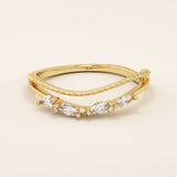 Curved beaded ring in 14k solid gold, featuring marquise and round moissanites. A unique nesting design perfect for stacking with solitaires.