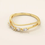 Curved beaded ring in 14k solid gold, featuring marquise and round moissanites. A unique nesting design perfect for stacking with solitaires.