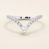 Curved stacking ring in 14k solid gold with a triangle moissanite at the peak and pavé moissanite accents. A modern, geometric nesting design.