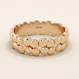 Daisy flower band ring in 14k solid gold, featuring tiny pavé moissanites. A thick yet delicate statement ring with floral charm.