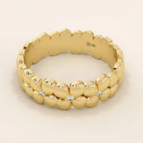 Daisy flower band ring in 14k solid gold, featuring tiny pavé moissanites. A thick yet delicate statement ring with floral charm.