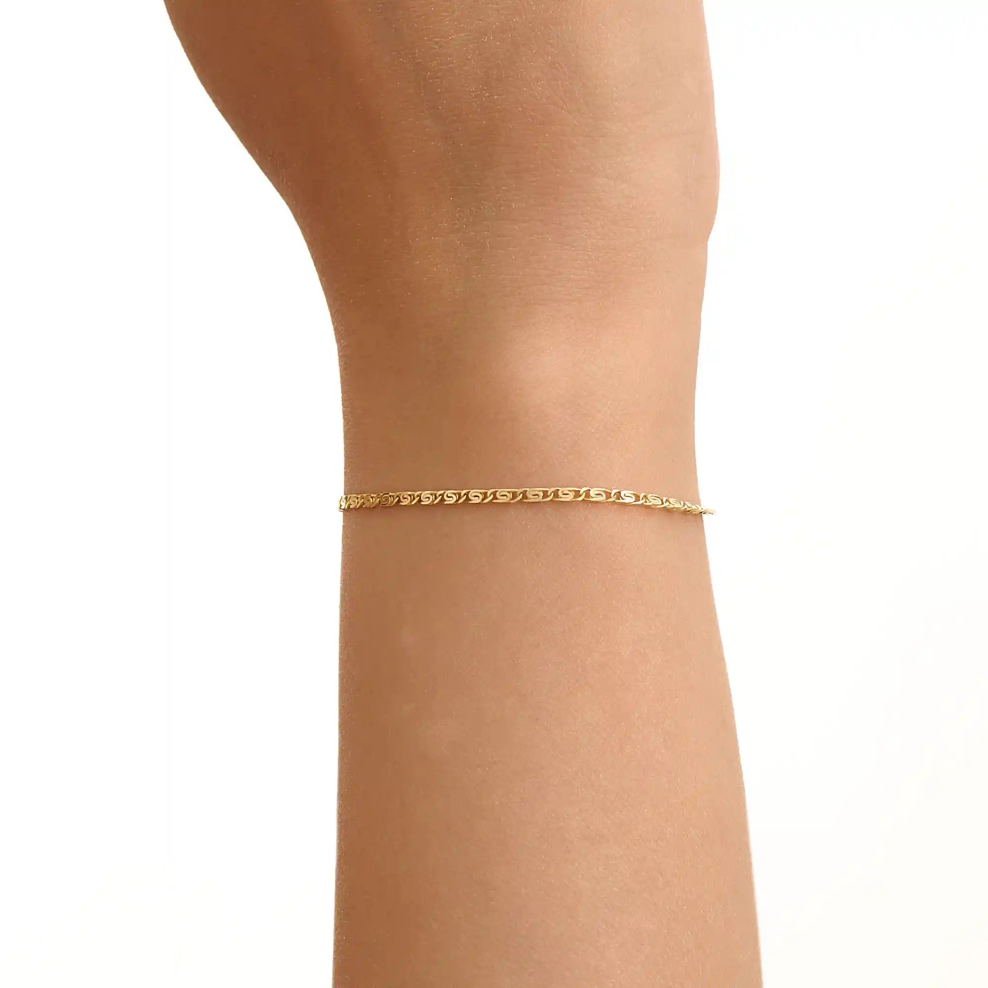 Model wearing a 14k gold scroll chain bracelet, showcasing the slim rectangular scroll link design on the wrist.